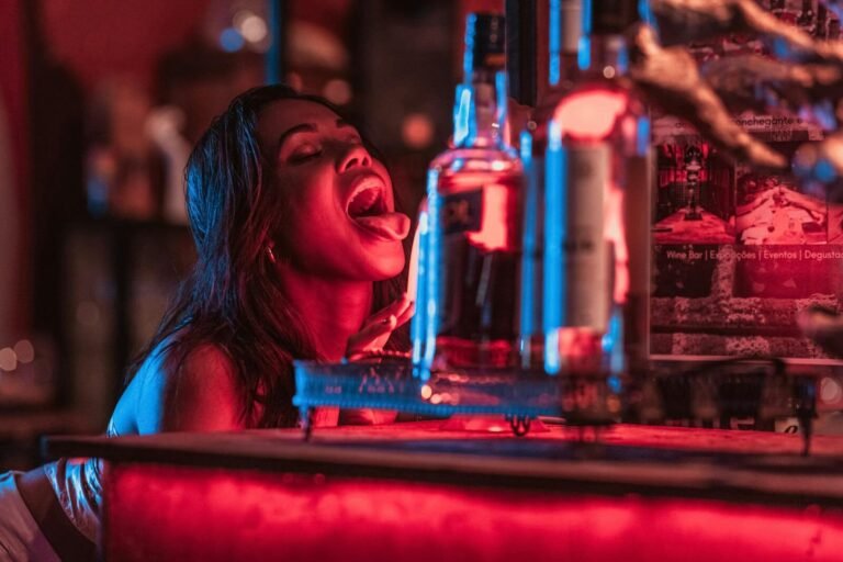 Woman Enjoying Nightlife In A Vibrant Bar Setting With Glowing Lights And Drinks In Rio De Janeiro.